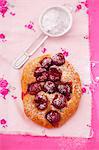 Sweet pastry with cherries and icing sugar