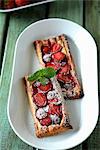 Puff pastry slices with strawberries and dusted with icing sugar