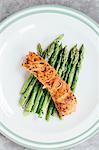 Grilled salmon fillet on a bed of green asparagus