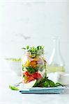Cherry tomato salad with corn salad and mozzarella in a jar
