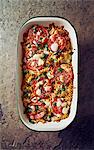 Pasta bake with tomatoes, mozzarella and parsley