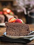 Piece of paleo (floverless and gluten free) chocolate cake with strawberries