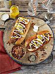 Chilli hot dogs topped with fried onion, mustard and mayonaise