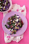 A salad with beetroot leaves, purple cauliflower and feta