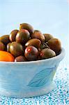 Black Amish Paste tomatoes in a ceramic bowl