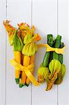 Bunches of yellow and green courgette with flowers, tied in a ribbon