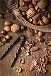 Festive bowl of mixed whole nuts in shells in a wooden bowl on a gold placemat