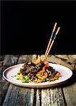 Pan-fried udon noodles with slow braised beef shank, kimchi and spring onions