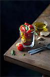 Fresh cherry tomato salad with basil and olive oil served in a glass