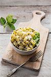 A bowl of pasta with basil pesto