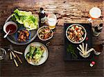 Various starters, salad and beer on a wooden table