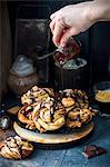 Swirl buns with a chocolate and cinnamon filling, chocolate sauce and walnuts