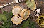 Three pieces of handmade fresh tortellini gigante, stuffed with spinach and chicken surrounded