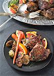 Chicken dinner with carrots brussels sprouts on dark plate background