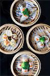Various Chinese steamed dumplings in bamboo steaming baskets