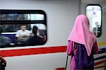 South-East Asia, Malaysia, Kuala Lumpur, veiled woman from the back waiting for the metro