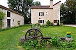 France, Lot, Montcuq, medieval watermill . Wrought iron wheel in the foreground