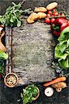 Healthy food ingredients background. Vegetables, herbs and spices. Organic vegetables on wood