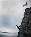 Businessman climbs a mountain to get to the flag. Achievement business goal and Difficult career concept