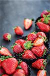 Fresh ripe strawberry on dark background, copy space