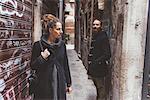 Couple with camera in alley, Venice, Italy