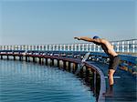 Swimmer diving from boardwalk, Eastern Beach, Geelong, Victoria, Australia