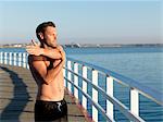 Swimmer stretching on boardwalk, Eastern Beach, Geelong, Victoria, Australia