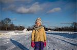 Girl in winter clothing on snow-covered path, Lakefield, Ontario, Canada