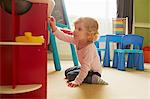 Female toddler playing on playroom floor