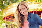 Women smiling, carousel in background, London, UK