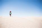 Female toddler standing on top of sand dune, Little Sahara, Utah, USA