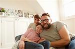 Portrait of mid adult man with son and daughter reclining on beanbag chair