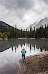 Portrait of woman beside lake, Kananaskis Country, Bow Valley Provincial Park, Kananaskis, Alberta, Canada