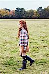 Young girl, walking through field