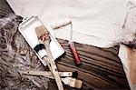 Still life of paint brushes and paint roller, overhead view