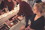 Male make up artist selecting make up for photo shoot