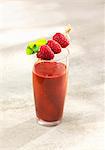 A raspberry and avocado smoothie with orange juice and dried mulberries