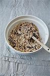 A bowl of muesli with coconut, cranberries, oats, almonds and puffed amaranth