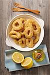 Fried squid rings with lemons and olive oil