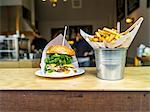 A hamburger and chips in a restaurant