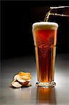 A glass of dark beer and crisps