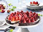 Strawberry tart, sliced, on a cake stand