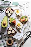 Open sandwiches with sweet and savoury toppings (seen from above)