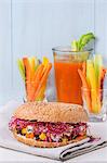 A bagel with carrots, blue cheese and beetroot sprouts