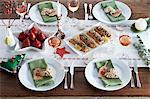 Various dishes on a table laid for Christmas