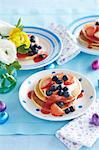Pancakes with cream, strawberry sauce and berries for Easter