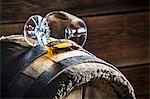A overturned glass of cognac on an old wooden barrel