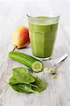 A green smoothie with cucumber, spinach, pear and wheatgrass