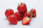 Several strawberries against a white background