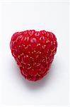 A raspberry on a white surface